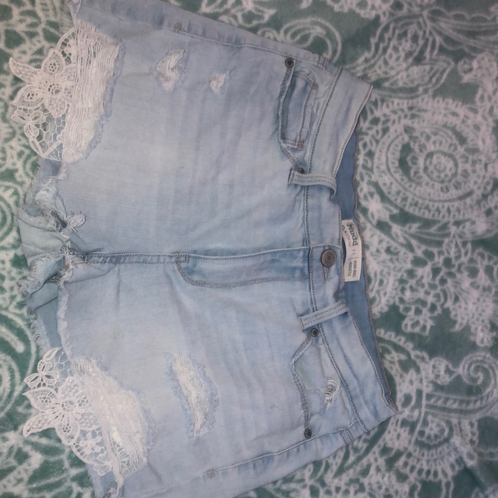 Ripped light washed blue jean shorts